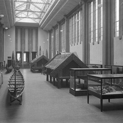 Maori artifacts, particularly waka (canoes) and pataka (storehouses), inside the Maori Hall at the Dominion Museum, Buckle Street, Wellington, circa 1936.