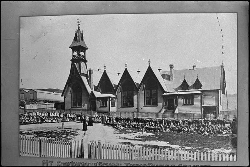 Pupils and teachers outside Mount Cook Infant School, Wellington, 1877.